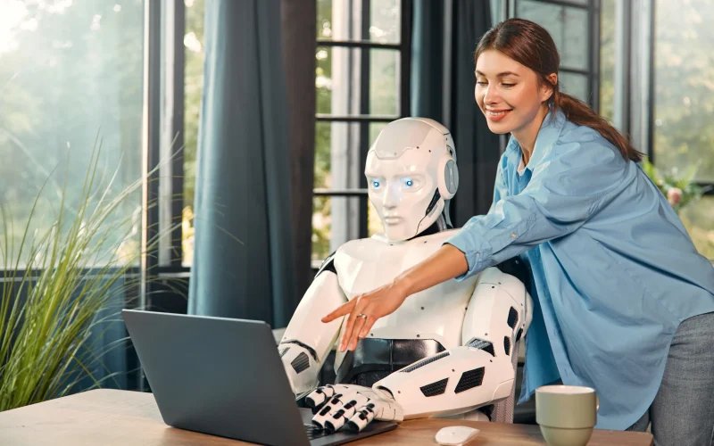 robot-and-woman-working-on-laptop-in-office-2025-03-25-03-05-53-utc